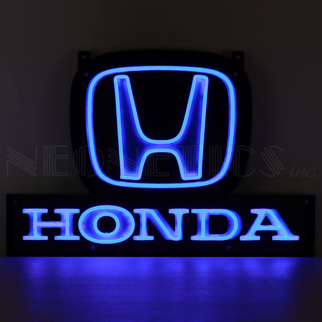 Blue neon Honda logo and sign glowing in darkness.
